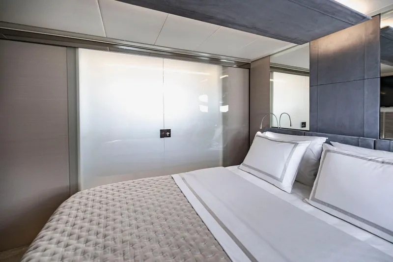 Slide: The Image of Luxurious bedroom interior on 2021 Pershing 62 yacht, featuring elegant bedding and modern design. - 94
