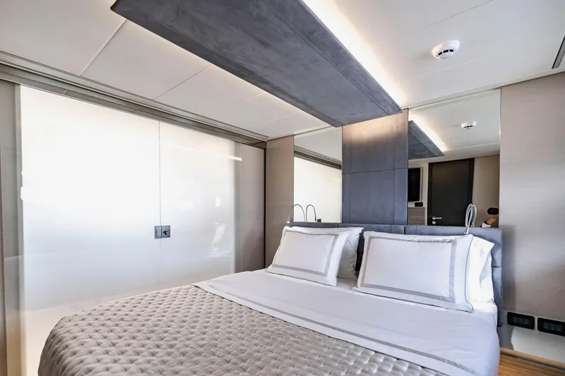 Slide: The Image of Luxurious bedroom interior on 2021 Pershing 62 yacht, featuring modern design and elegant bedding. - 95
