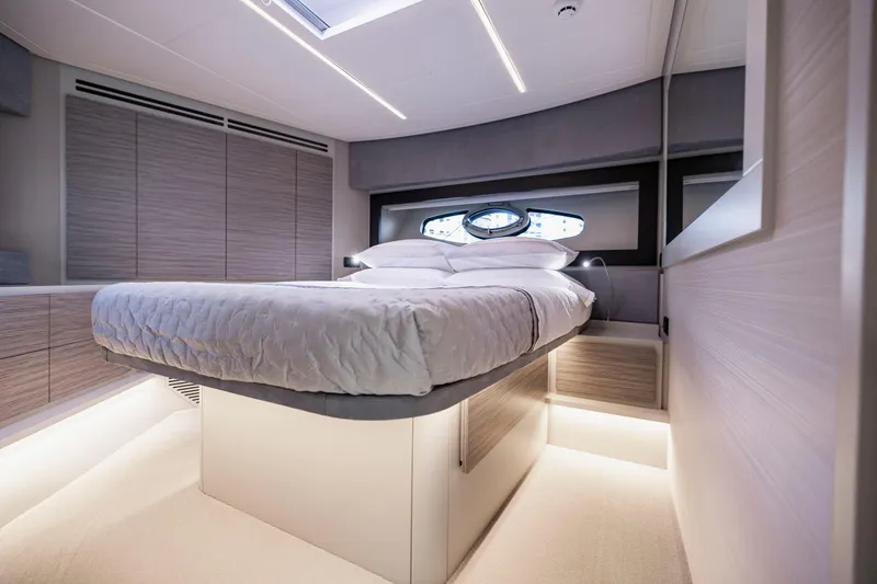 Slide: The Image of Luxurious bedroom interior of 2021 Pershing 62 yacht with modern design and ambient lighting. - 96