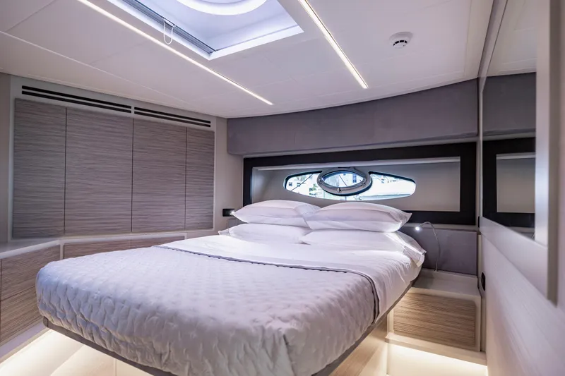 Slide: The Image of Luxurious bedroom interior of 2021 Pershing 62 yacht with modern design and skylight. - 97