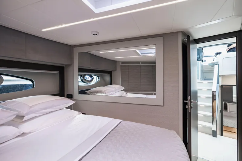 Slide: The Image of Luxurious bedroom interior of 2021 Pershing 62 yacht with modern design and large mirror. - 98