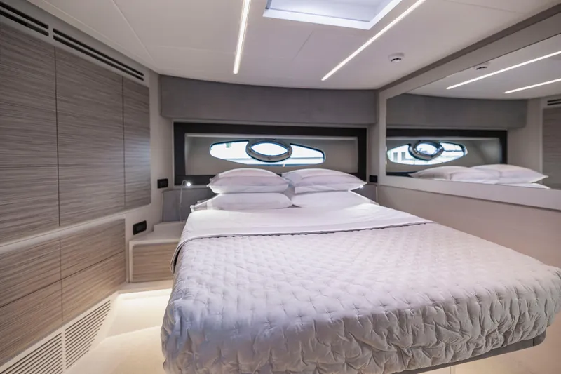 Slide: The Image of Luxurious bedroom interior of 2021 Pershing 62 yacht with modern design and elegant bedding. - 99