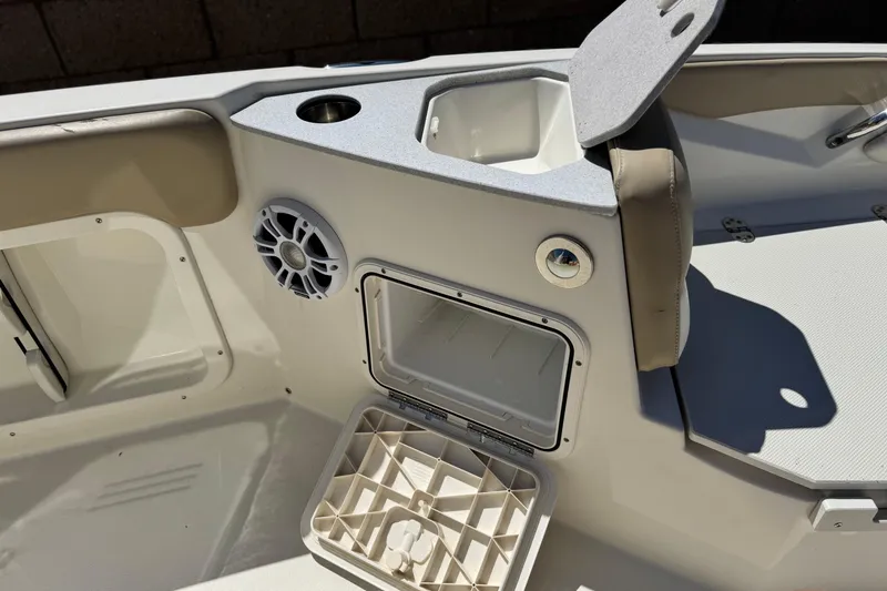 Slide: The Image of Interior of 2019 Stingray 206 CC boat showing storage compartments and speaker. - 12