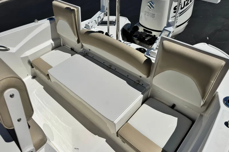 Slide: The Image of 2019 Stingray 206 CC boat interior with beige and white seating, Suzuki outboard motor. - 16