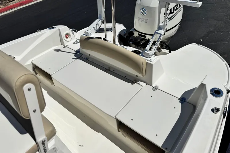Slide: The Image of 2019 Stingray 206 CC boat interior with Suzuki 175 outboard motor, featuring seating and storage. - 17