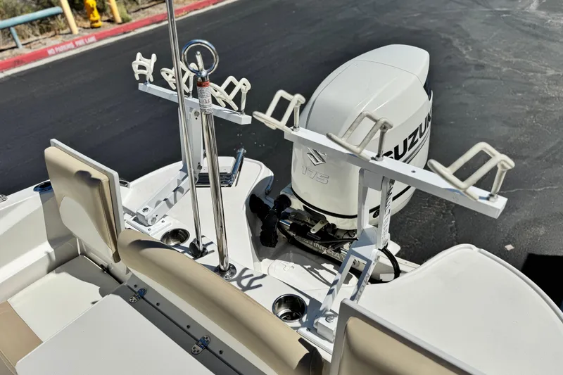 Slide: The Image of 2019 Stingray 206 CC boat with Suzuki 175 outboard motor and rod holders. - 19