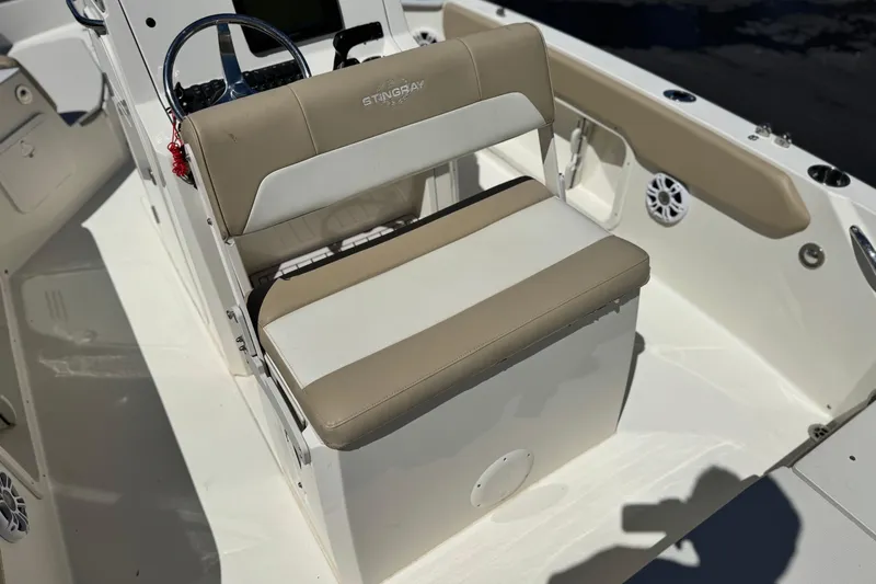 Slide: The Image of 2019 Stingray 206 CC boat interior with beige and white seating. - 21