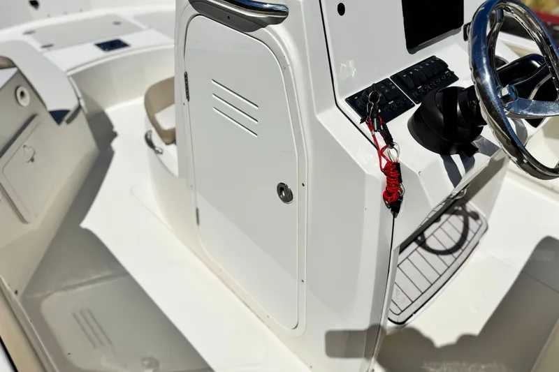 Slide: The Image of 2019 Stingray 206 CC boat interior with steering wheel and control panel. - 27