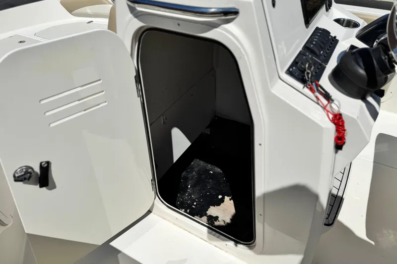 Slide: The Image of Open storage compartment on a 2019 Stingray 206 CC boat, showcasing interior space. - 28