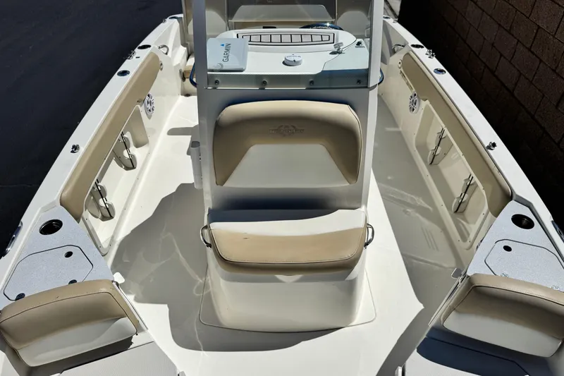 Slide: The Image of 2019 Stingray 206 CC boat interior with beige seating and Garmin navigation system. - 9