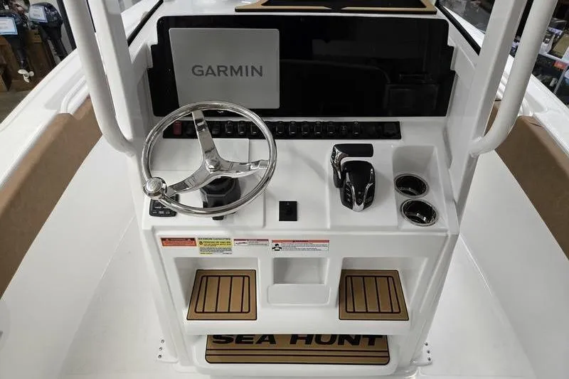 Slide: The Image of 2026 Sea Hunt Ultra 245 SE boat console with Garmin navigation system and steering wheel. - 10