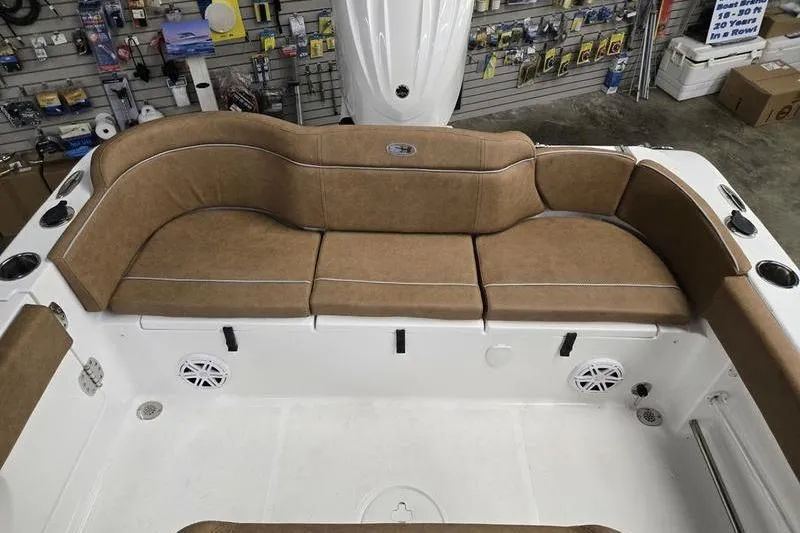 Slide: The Image of 2026 Sea Hunt Ultra 245 SE boat interior with tan cushioned seating. - 11