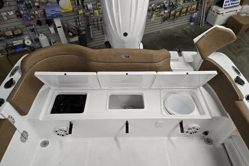 Slide: The Image of 2026 Sea Hunt Ultra 245 SE boat interior with storage compartments open. - 16