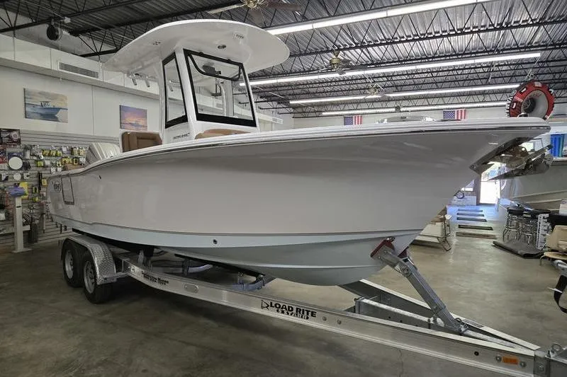 Slide: The Image of 2026 Sea Hunt Ultra 245 SE boat on trailer in showroom. - 18