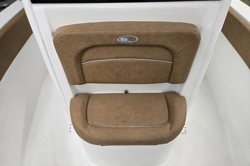 Slide: The Image of 2026 Sea Hunt Ultra 245 SE boat seat with brown upholstery and logo. - 2