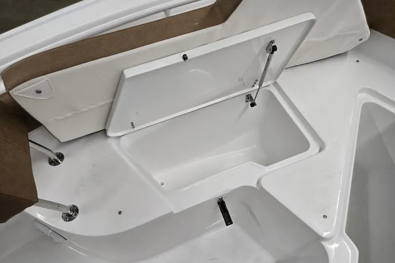 Slide: The Image of Storage compartment on 2026 Sea Hunt Ultra 245 SE boat, featuring white interior and brown seating. - 3