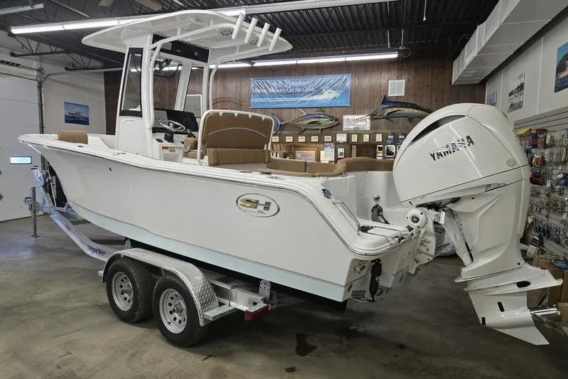 Slide: The Image of 2026 Sea Hunt Ultra 245 SE boat with Yamaha engine on trailer in showroom. - 4
