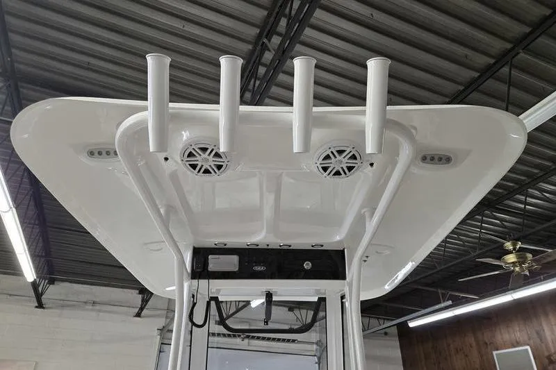 Slide: The Image of 2026 Sea Hunt Ultra 245 SE boat T-top with rod holders and speakers. - 7