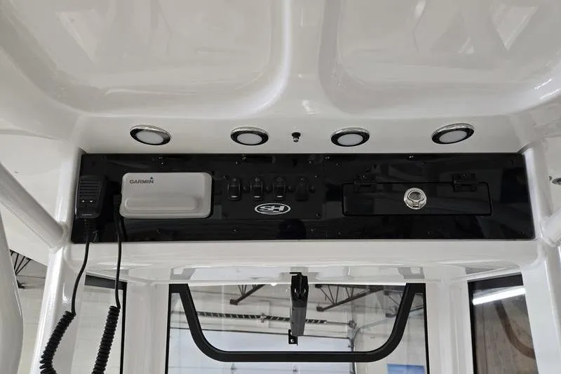 Slide: The Image of 2026 Sea Hunt Ultra 245 SE boat console with Garmin electronics and control panel. - 9