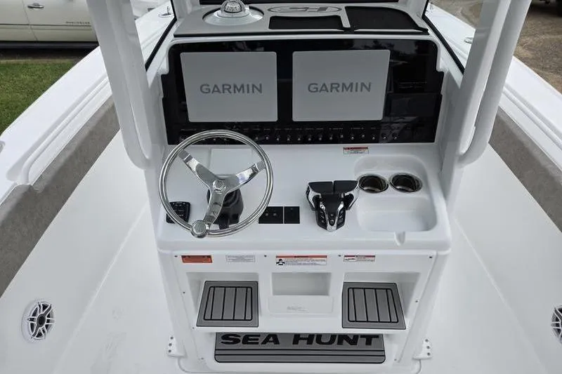 Slide: The Image of 2026 Sea Hunt Ultra 275 SE boat console with Garmin displays and steering wheel. - 12