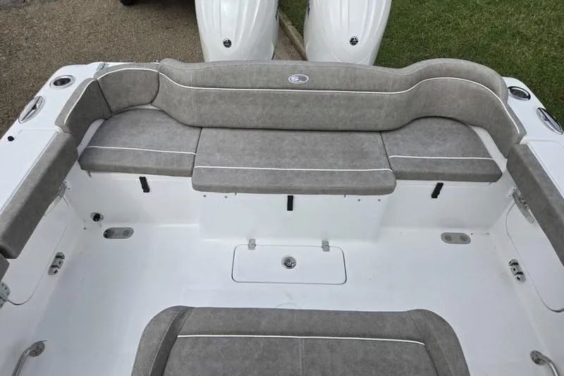 Slide: The Image of 2026 Sea Hunt Ultra 275 SE boat interior with gray cushioned seating. - 2