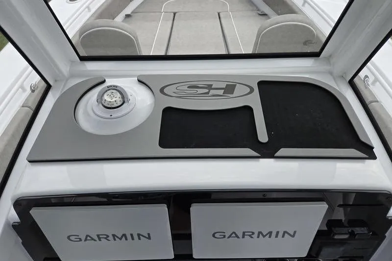Slide: The Image of 2026 Sea Hunt Ultra 275 SE dashboard with Garmin displays and compass. - 23