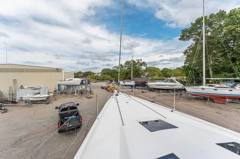 Slide: The Image of Italia Yachts 13.98 (2015) in a boatyard with other vessels and equipment. - 10