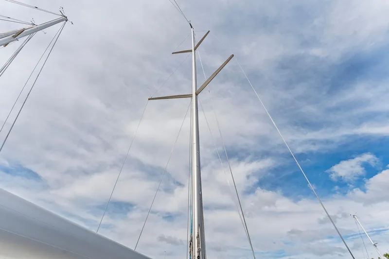 Slide: The Image of Mast of 2015 Italia Yachts 13.98 against a cloudy blue sky. - 13