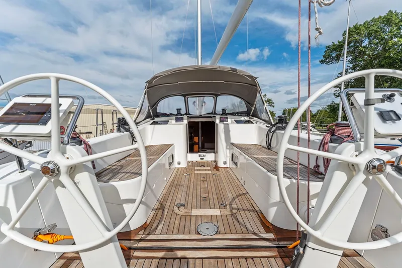 Slide: The Image of Italia Yachts 13.98 (2015) sailboat cockpit with dual steering wheels and teak decking. - 16