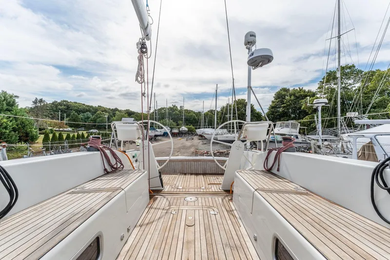 Slide: The Image of Italia Yachts 13.98 (2015) sailboat with wooden deck, docked in a marina. - 20