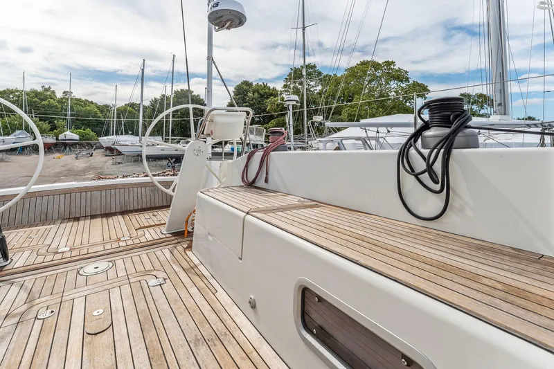 Slide: The Image of Italia Yachts 13.98 (2015) sailboat deck with wooden finish and dual steering wheels. - 22