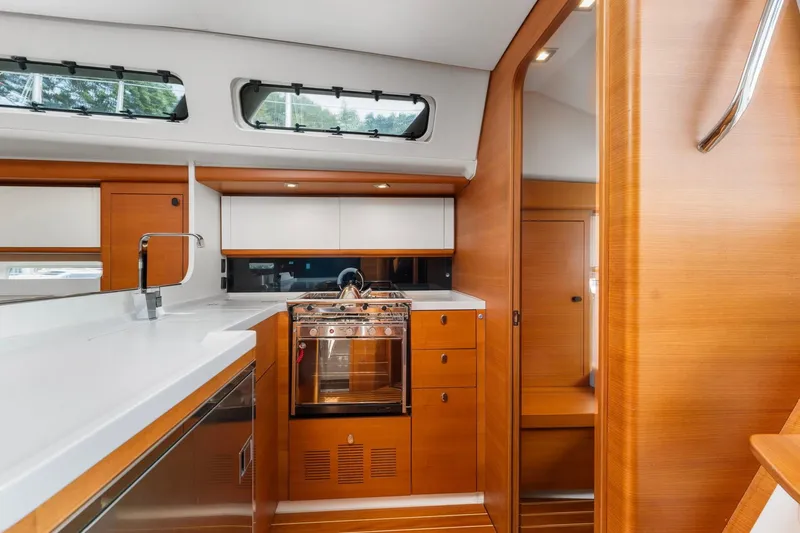 Slide: The Image of Luxurious interior of 2015 Italia Yachts 13.98, featuring modern kitchen and sleek wood finishes. - 29