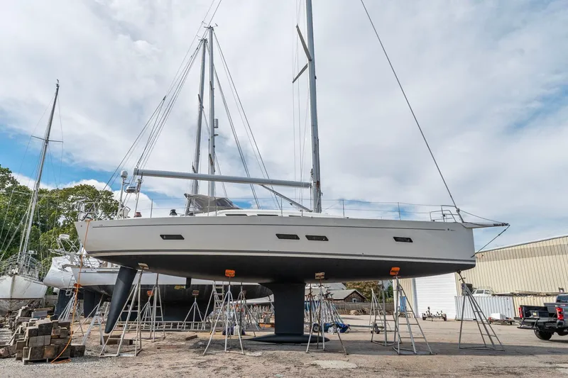 Slide: The Image of Italia Yachts 13.98 sailboat from 2015 on dry dock, surrounded by other boats. - 3