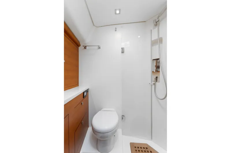 Slide: The Image of Modern yacht bathroom with shower, wooden cabinetry, and toilet in 2015 Italia Yachts 13.98. - 39
