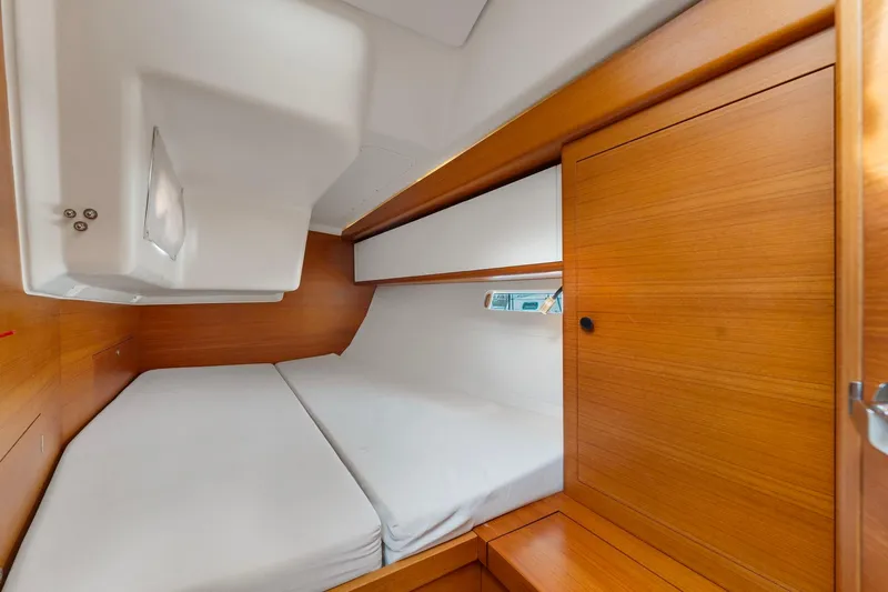 Slide: The Image of Cozy cabin interior of 2015 Italia Yachts 13.98, featuring wooden finishes and a comfortable bed. - 40