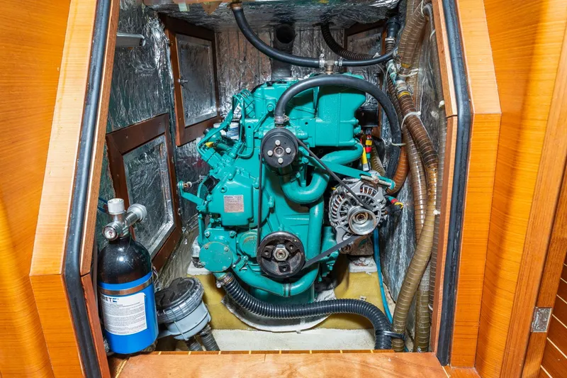 Slide: The Image of Engine compartment of 2015 Italia Yachts 13.98, featuring a green marine engine. - 44