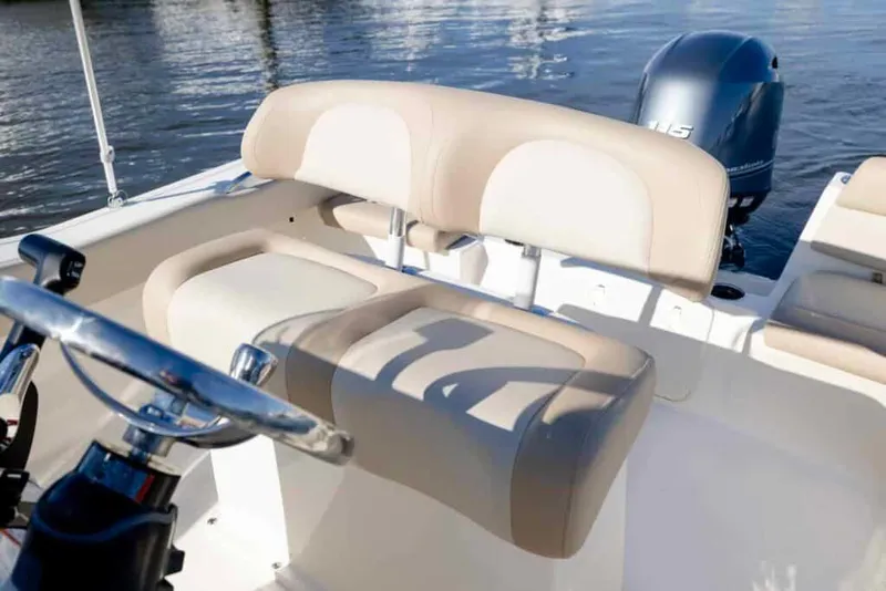 Slide: The Image of Manufacturer Provided Image: 2025 Scout 195 Sportfish boat interior with beige seating and steering wheel. - 9