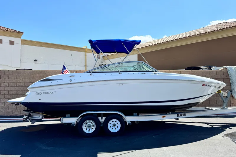 The Image of 2008 Cobalt 262 boat on trailer with blue canopy, parked outdoors. - 0