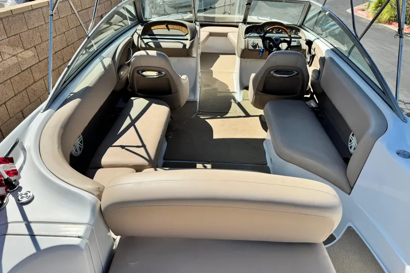 Slide: The Image of Interior of a 2008 Cobalt 262 boat with beige seating and steering wheel. - 10