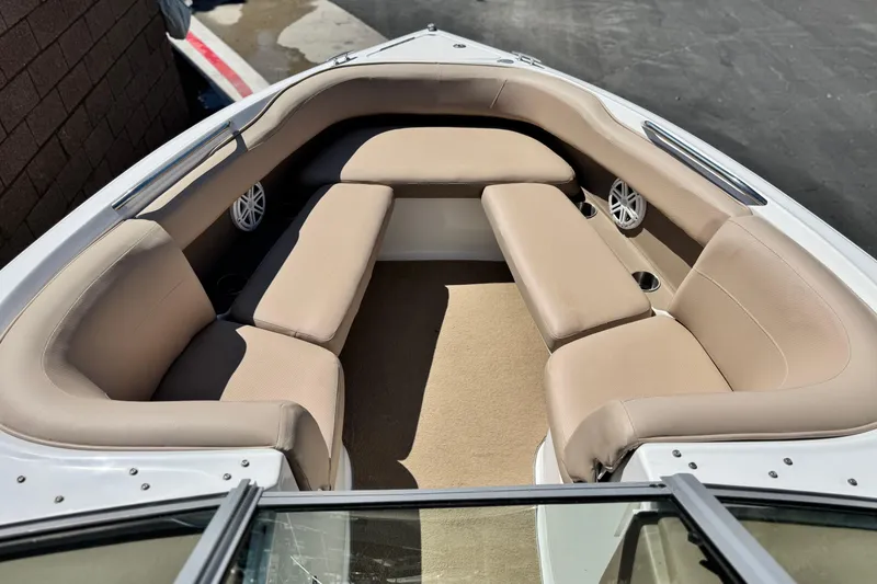 Slide: The Image of Interior of a 2008 Cobalt 262 boat with beige seating and speakers. - 11
