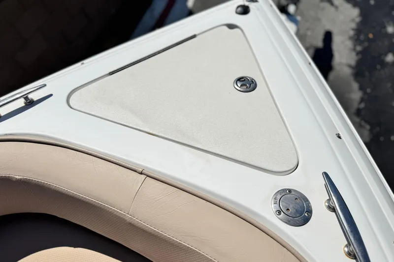 Slide: The Image of 2008 Cobalt 262 boat deck with beige seating and metal fixtures. - 14