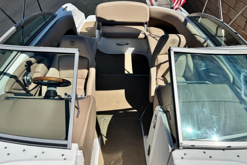 Slide: The Image of 2008 Cobalt 262 boat interior with beige seating and steering wheel. - 16