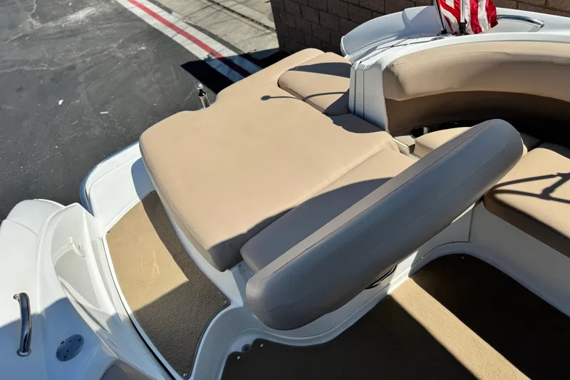 Slide: The Image of 2008 Cobalt 262 boat interior with beige seating and American flag detail. - 18
