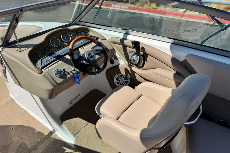 Slide: The Image of Interior of a 2008 Cobalt 262 boat with beige seating and dashboard controls. - 25