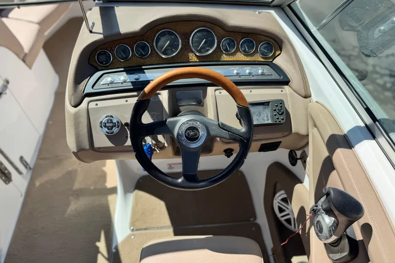 Slide: The Image of 2008 Cobalt 262 boat dashboard with steering wheel and control panel. - 26
