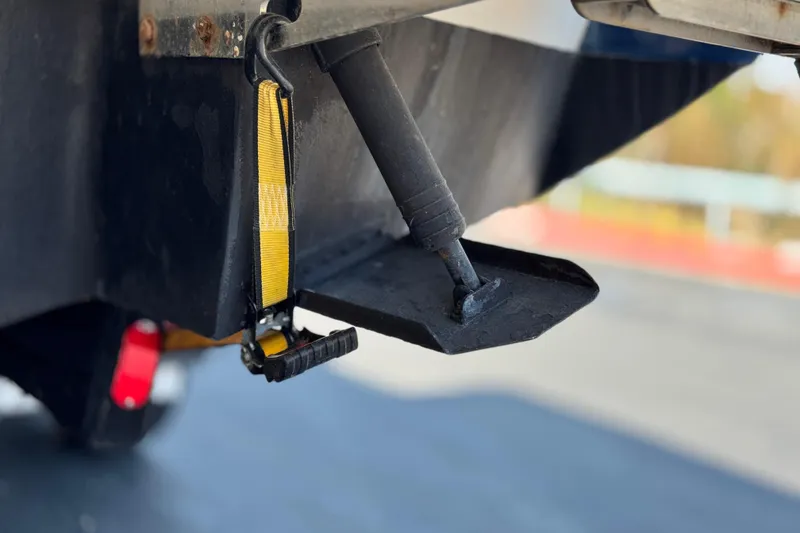 Slide: The Image of Close-up of a 2008 Cobalt 262 boat's trim tab and strap mechanism. - 8