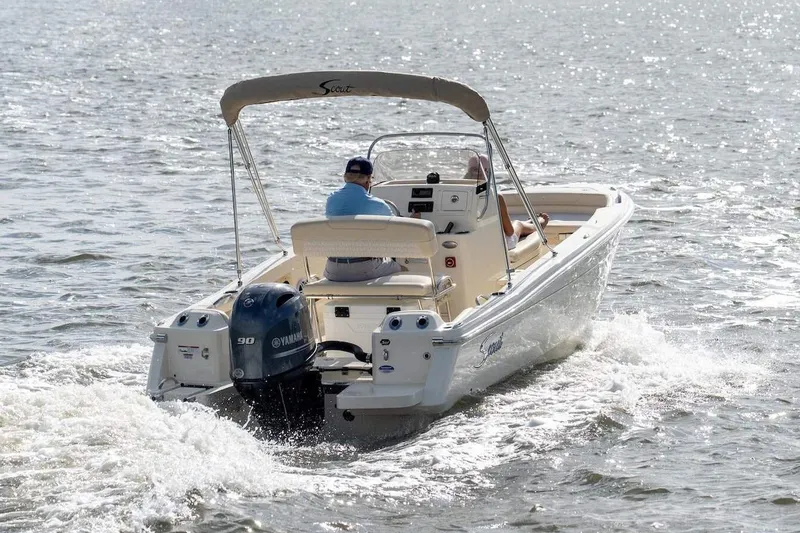 Slide: The Image of Manufacturer Provided Image: 2026 Scout 188 Sportfish boat cruising on open water, rear view. - 2