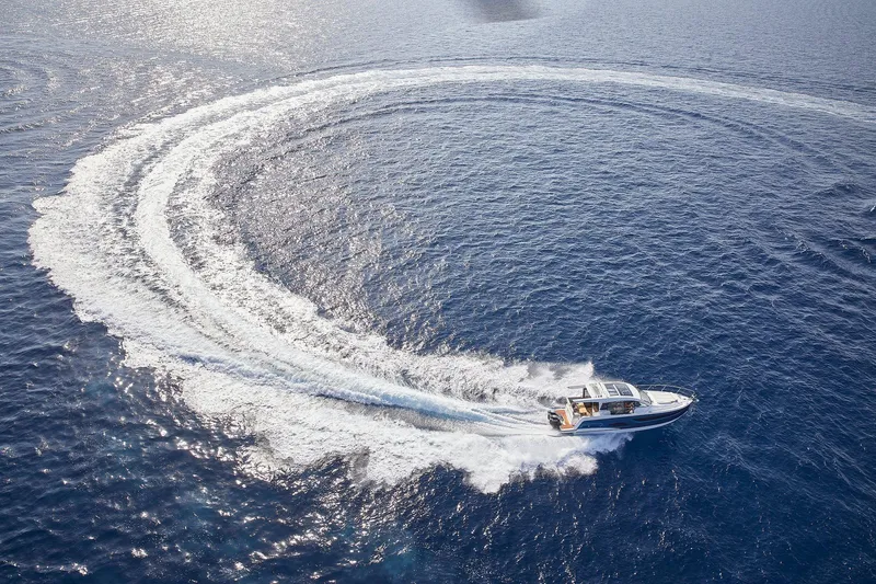 Slide: The Image of 2026 Sealine C390 yacht making a circular wake on open blue water. - 10