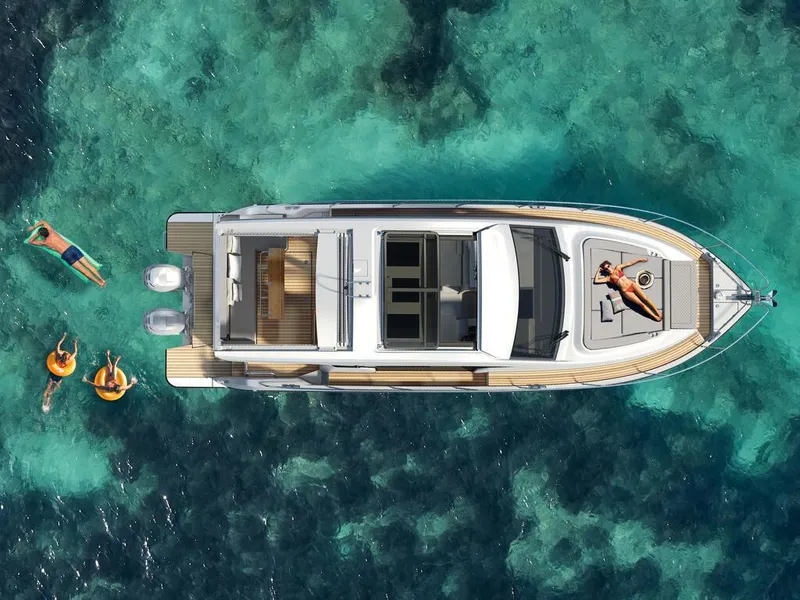 Slide: The Image of Aerial view of 2026 Sealine C390 yacht on clear turquoise water, with people swimming nearby. - 11