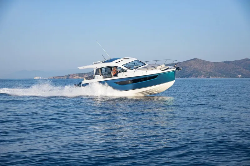 Slide: The Image of 2026 Sealine C390 yacht cruising on open water with scenic mountain backdrop. - 12